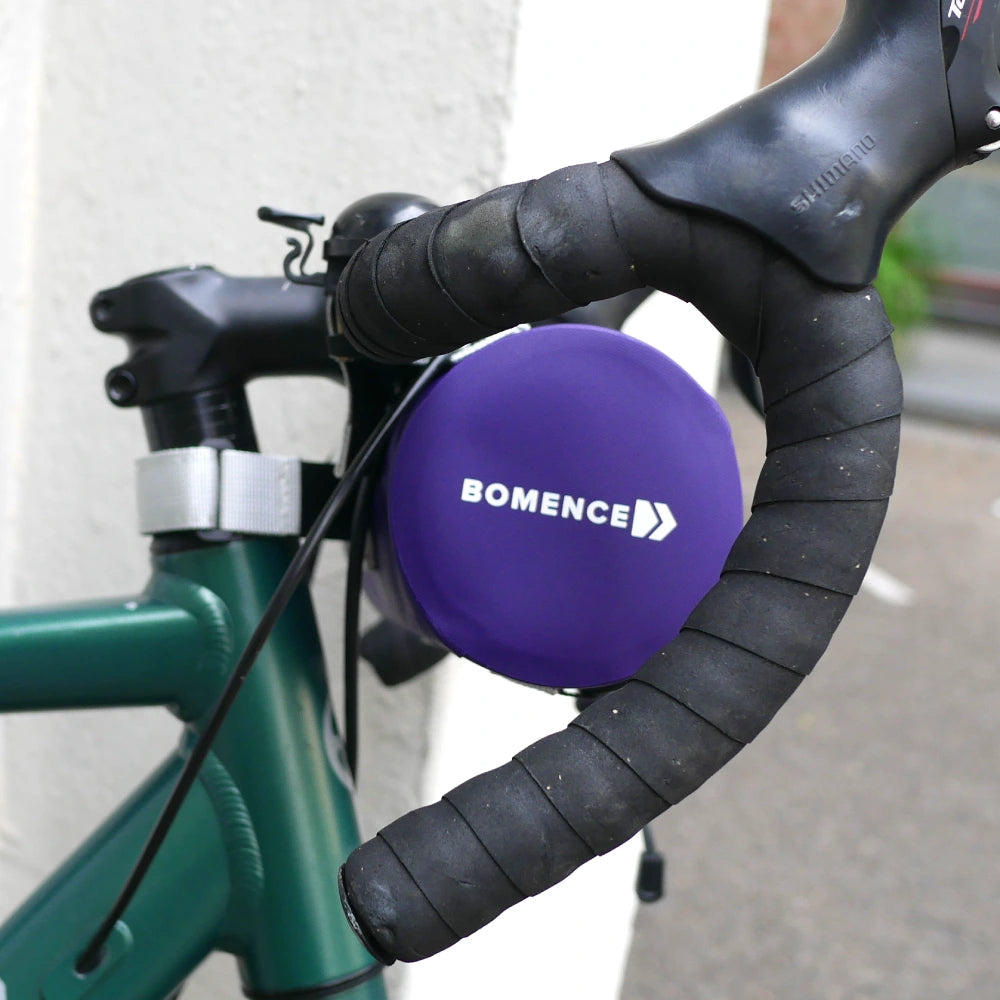 Runde Lenkertasche aus wasserdichtem Material von der Seite von Bomence in der Farbe lila am Lenker eines Rennrads